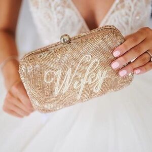 St Xavier “Wifey” beaded bridal clutch in champagne